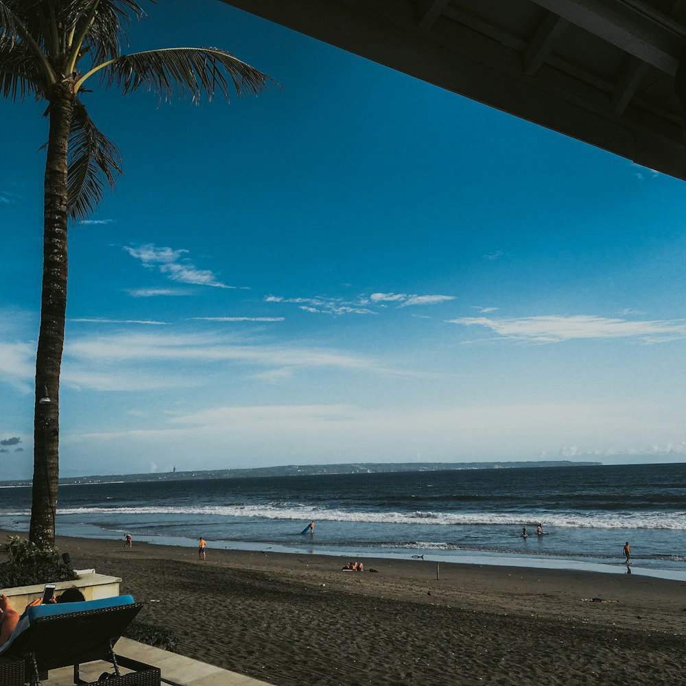 a person sitting on a bench on a beach