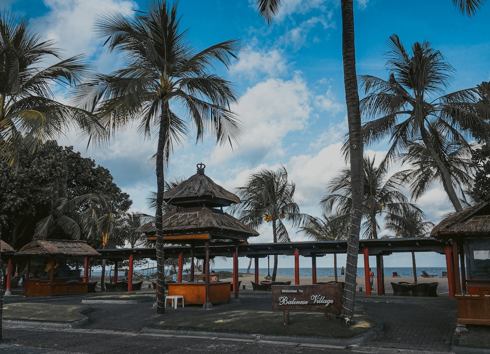 a gazebo on a tropical beach with palm trees