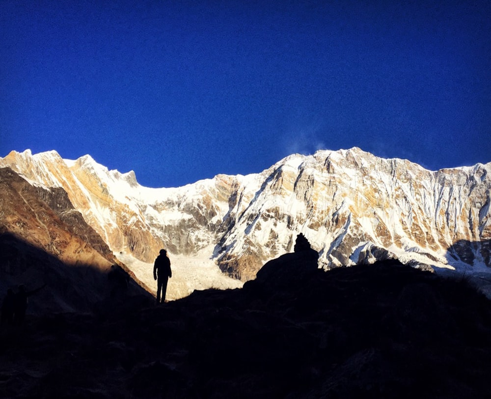 a man standing on top of a snow covered mountain