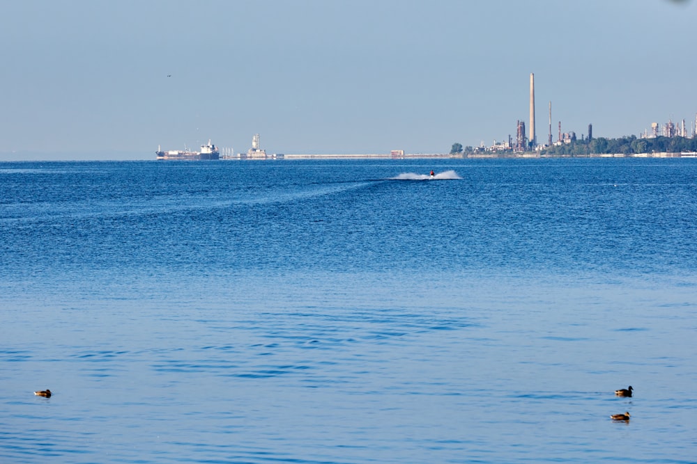 a boat is out on the water with a city in the background