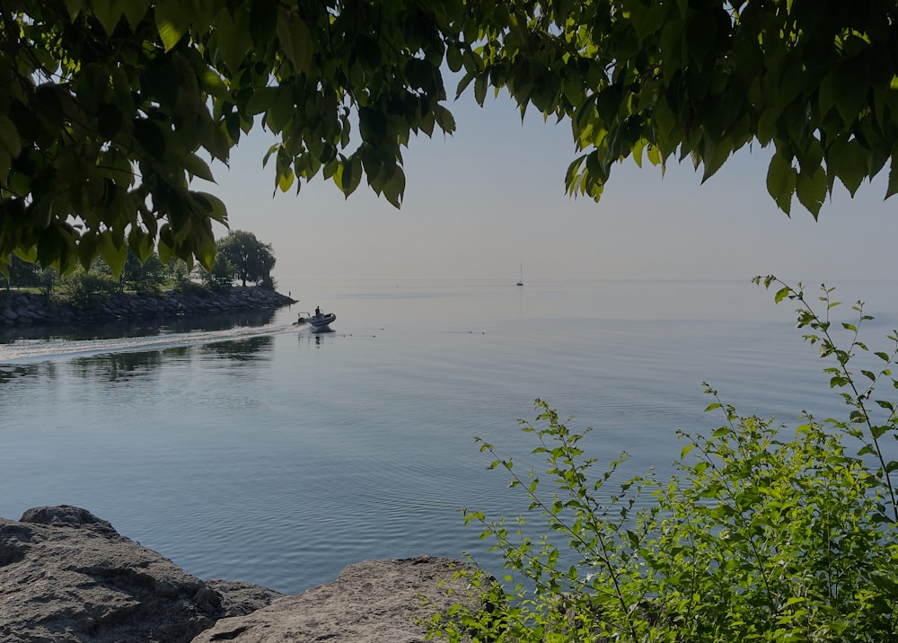 a boat is out on the water near the shore