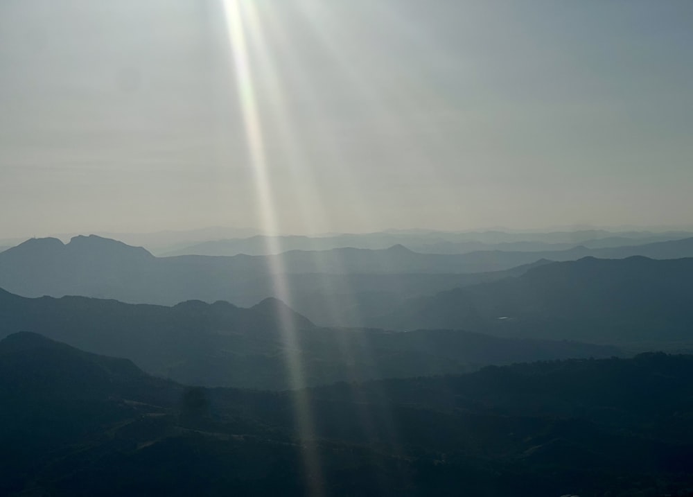 the sun is shining brightly over the mountains