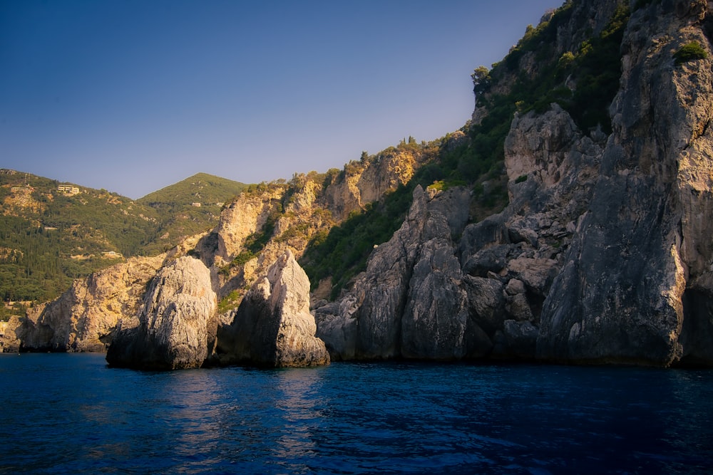 a large rock formation in the middle of a body of water