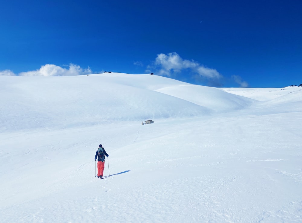 a person riding skis on top of a snow covered slope