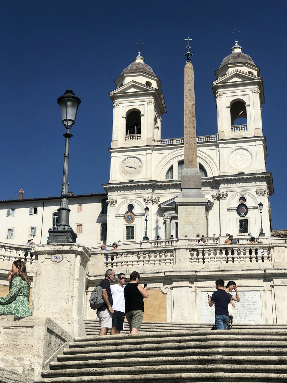 a group of people standing on top of a set of stairs