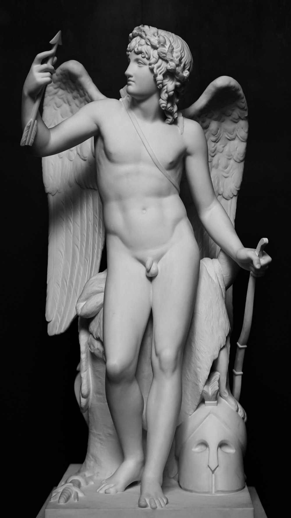 a black and white photo of a statue of an angel