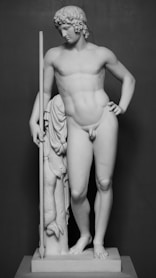 a black and white photo of a statue of a man