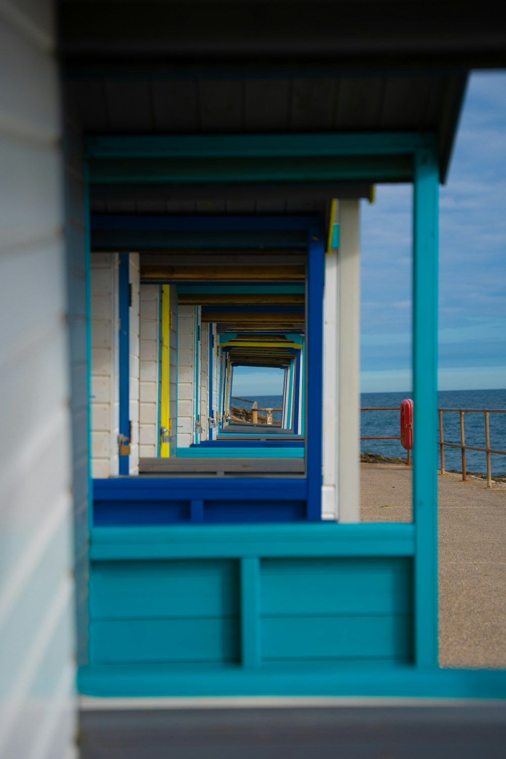 a row of beach huts sitting next to the ocean