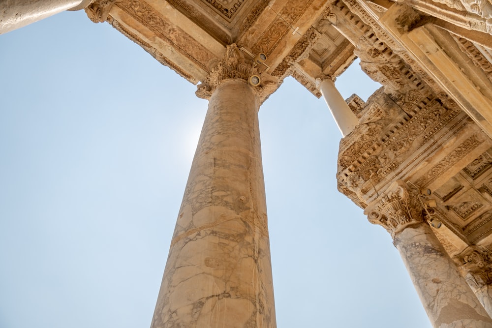 looking up at the columns of a roman temple