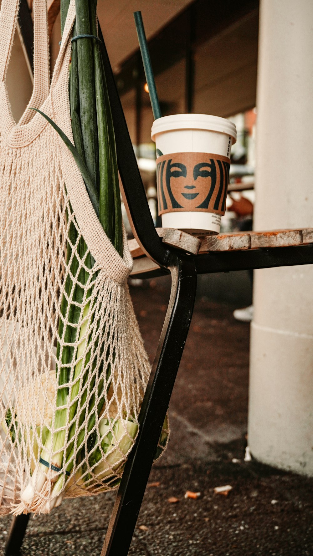 a cup of coffee sitting on top of a chair