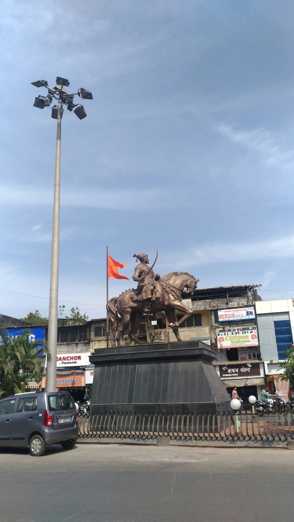 a statue of a man on a horse with two bulls