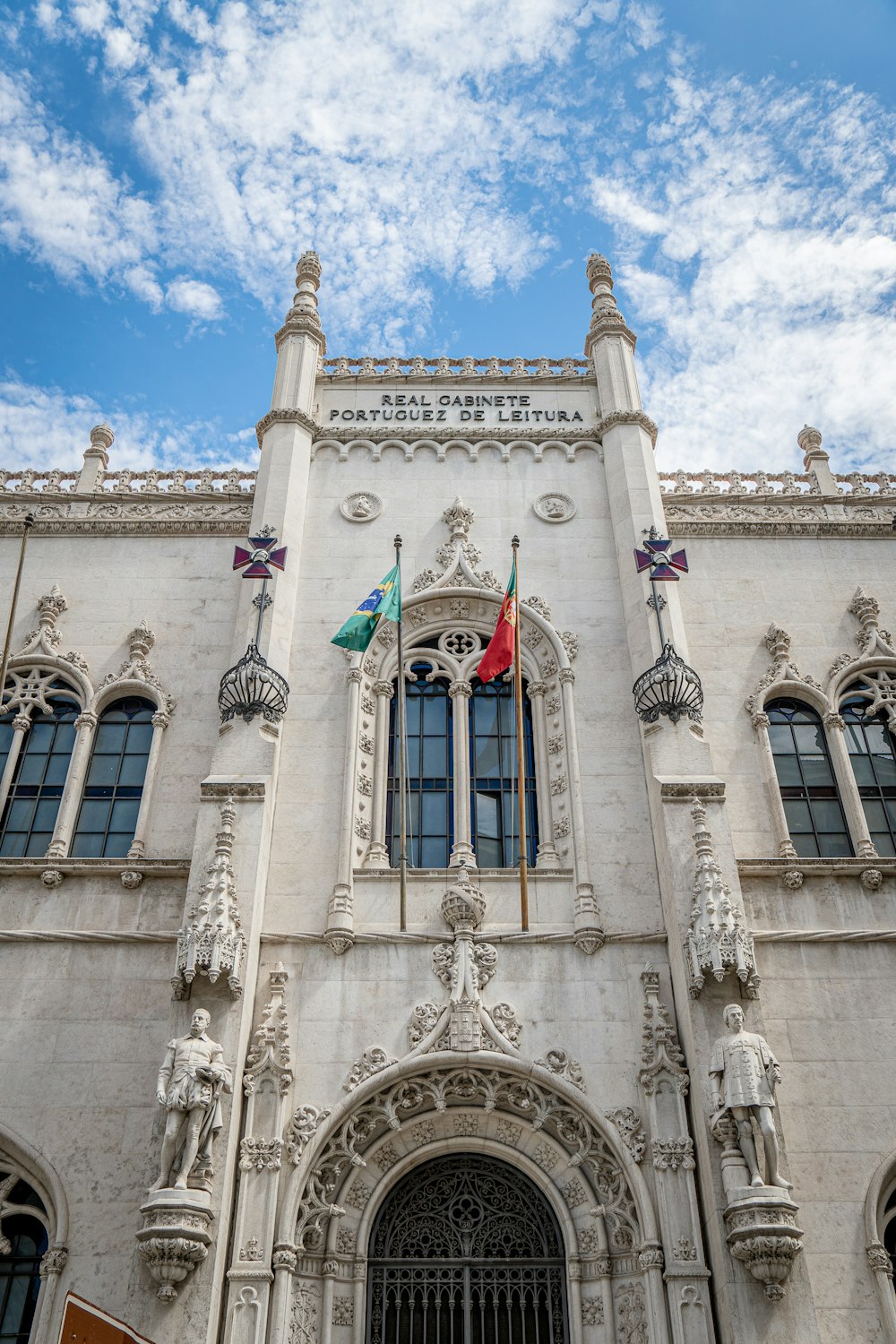 a tall white building with a clock on the front of it