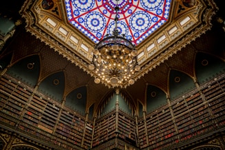 The interior of Livraria Lello showcasing its ornate staircase and stained glass ceiling.