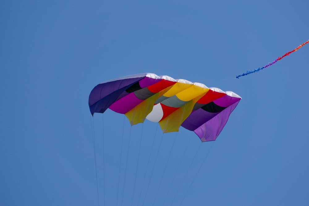 a colorful kite flying in a blue sky