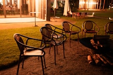 Cozy corner of the resort’s large lawn set up for a relaxed outdoor event with soft lighting in the dusk.
