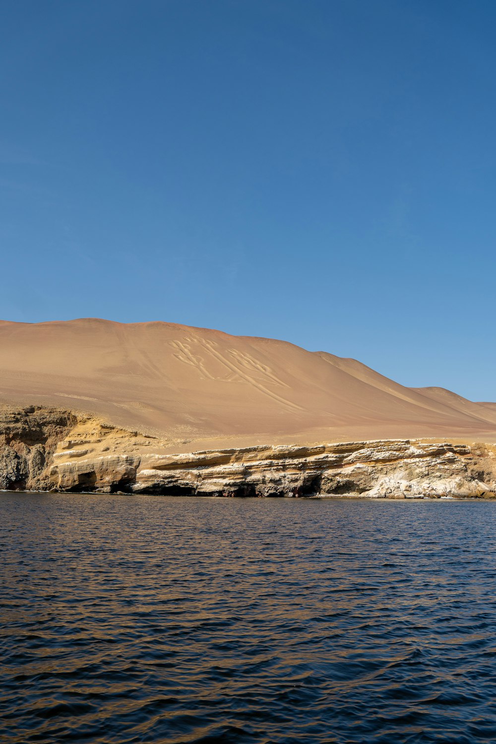 a body of water with a mountain in the background