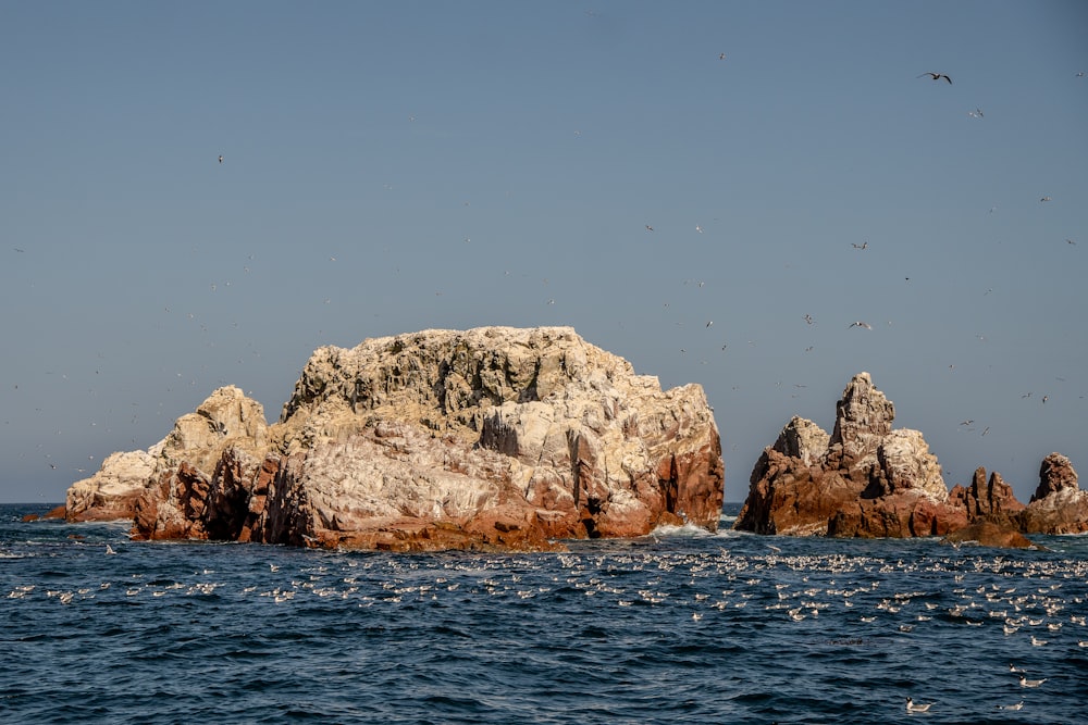 a large rock formation in the middle of the ocean