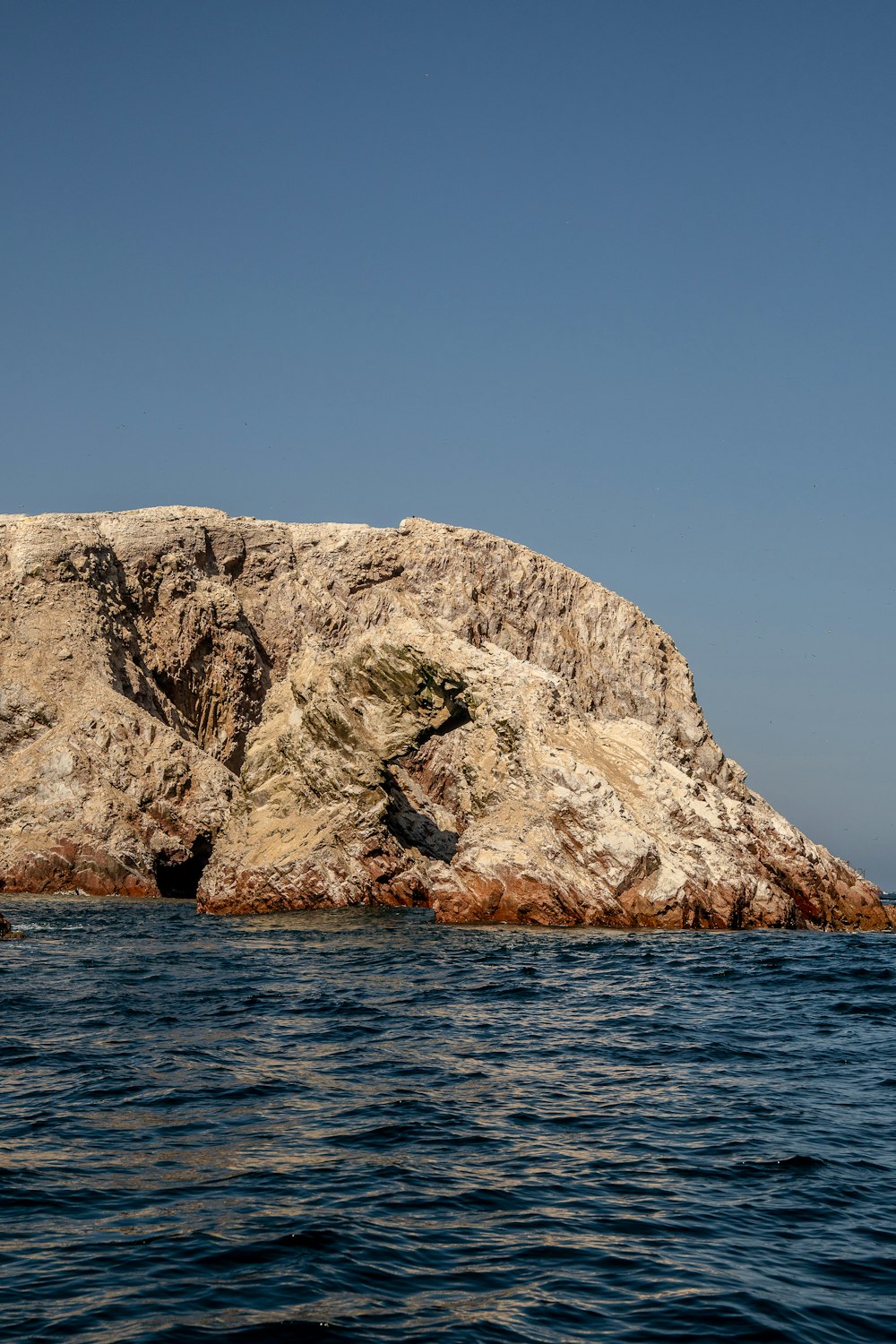 a rock outcropping in the middle of the ocean