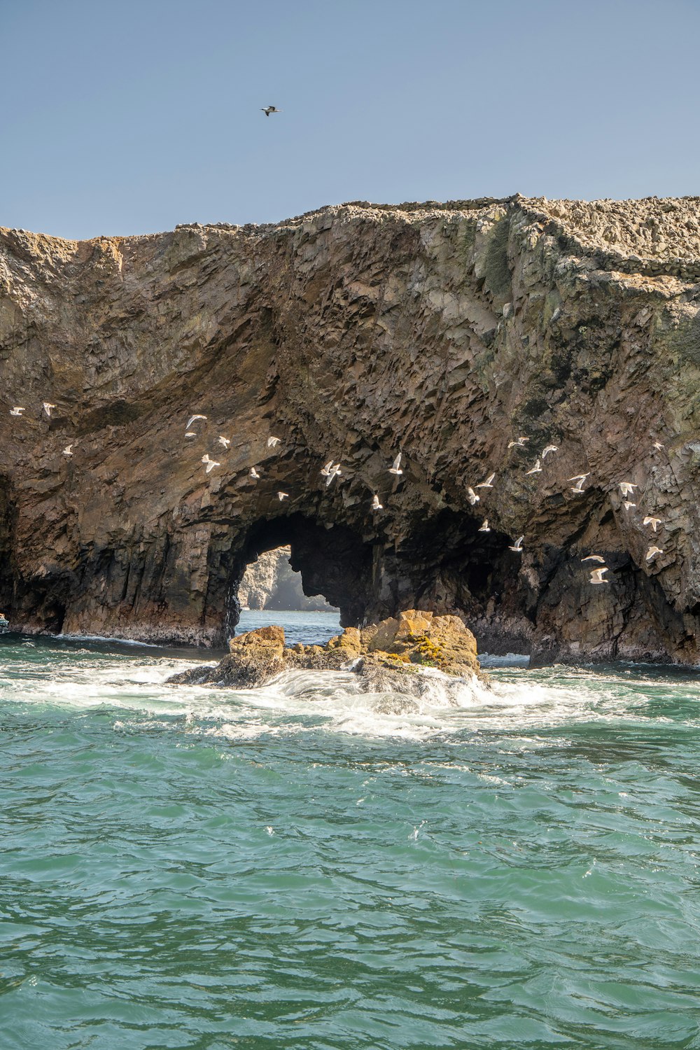 a large rock formation with a cave in the middle of it