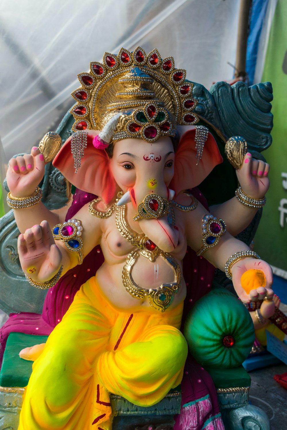 a statue of a ganesh sitting on a chair