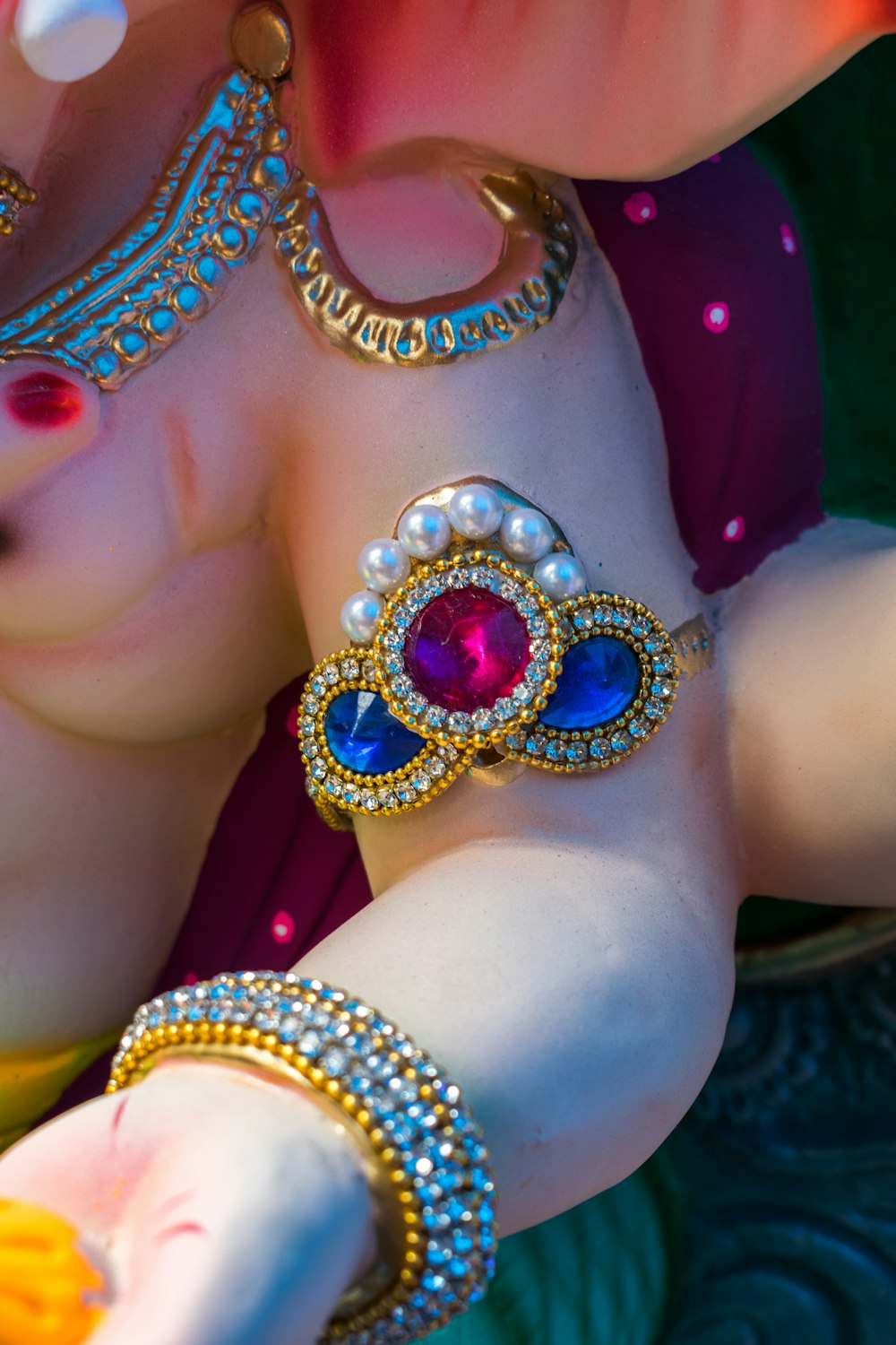 a close up of a statue of a woman wearing jewelry