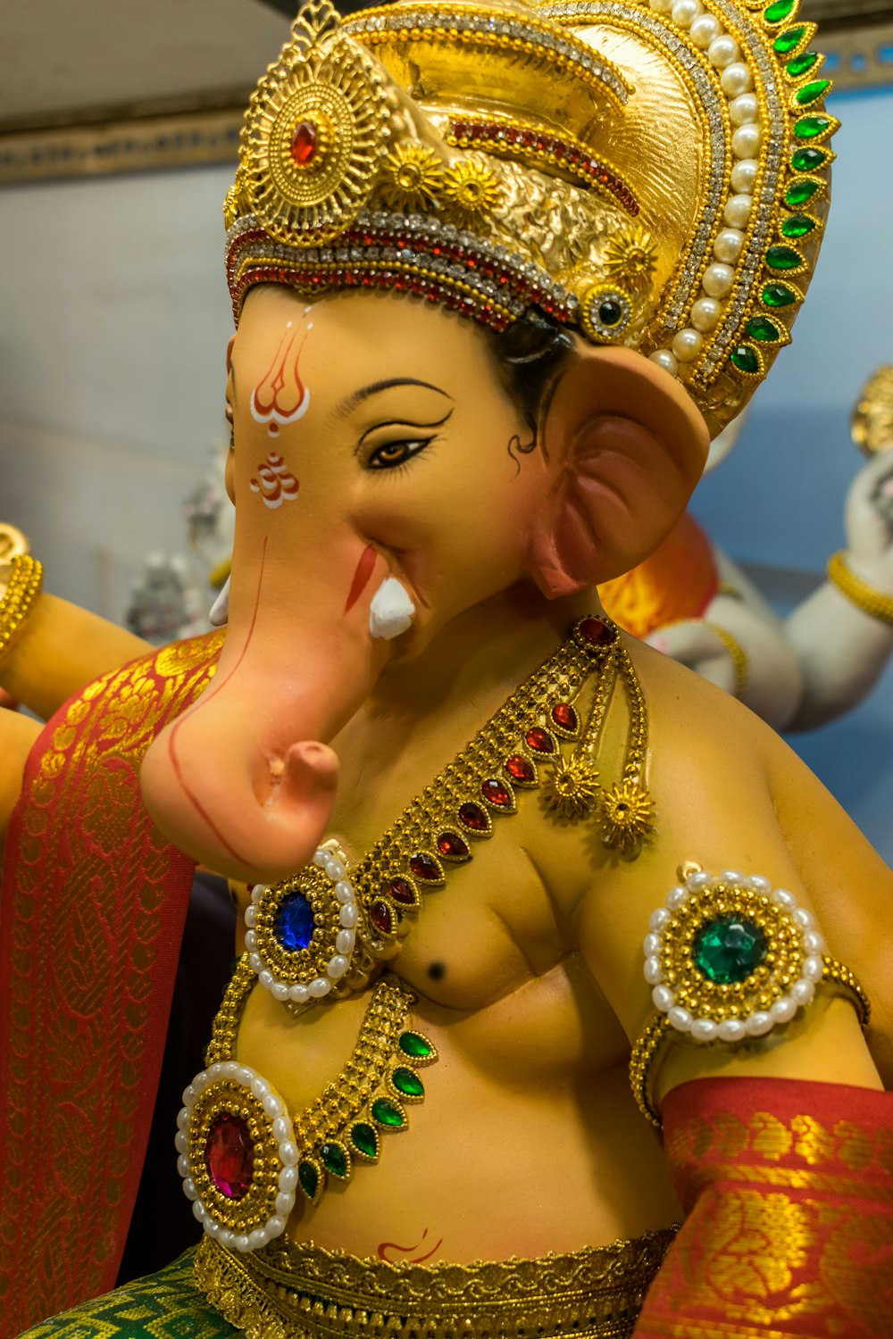 a statue of an elephant wearing a gold headdress