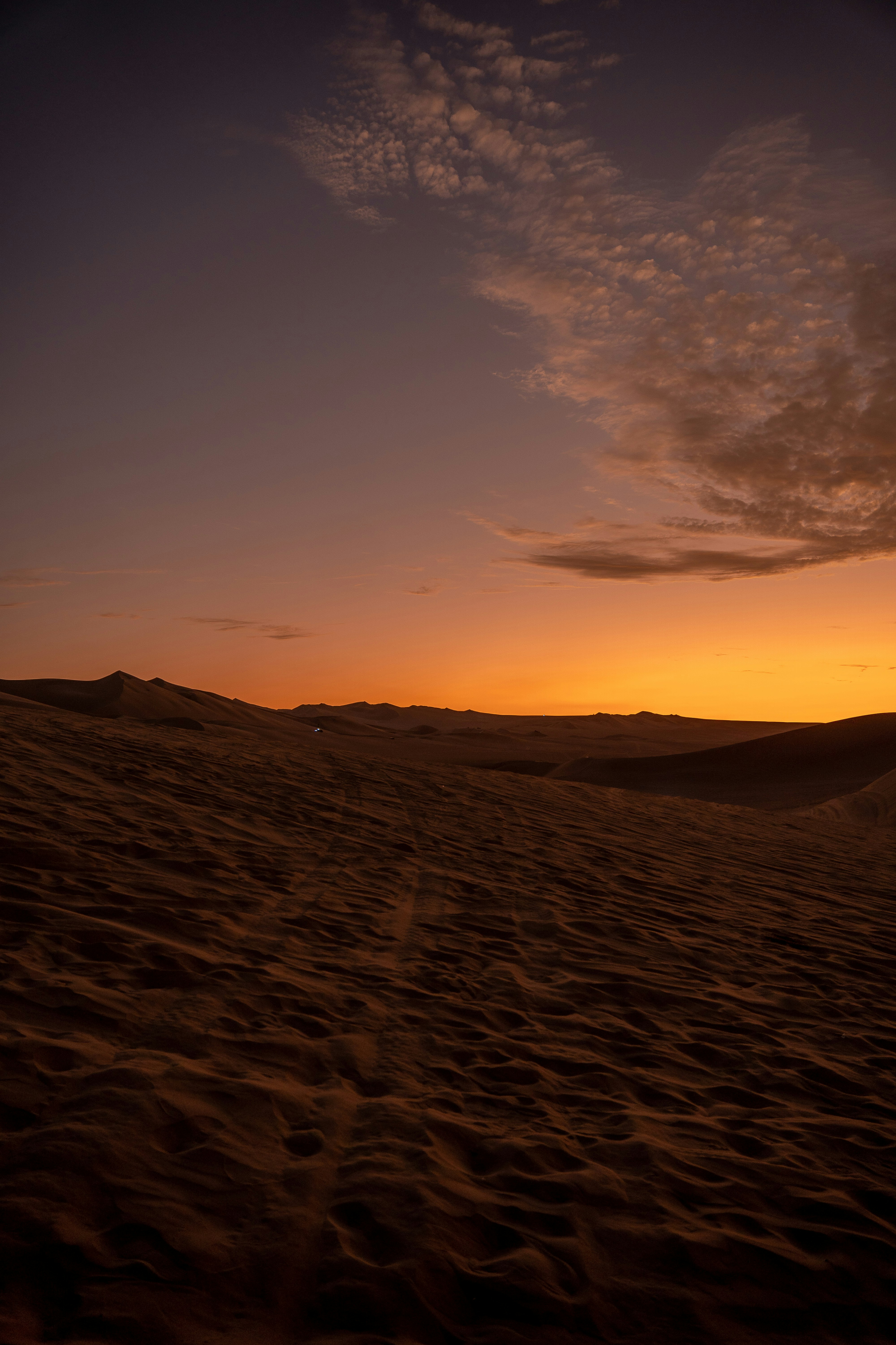 the sun is setting over a desert landscape