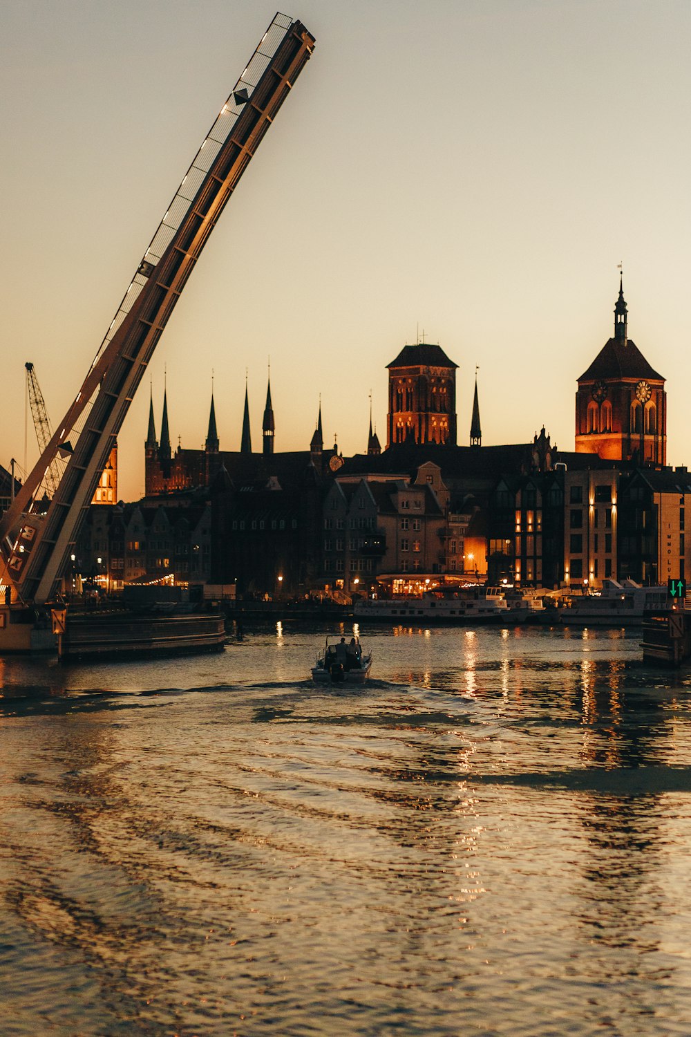 a crane is lifting a boat into the water