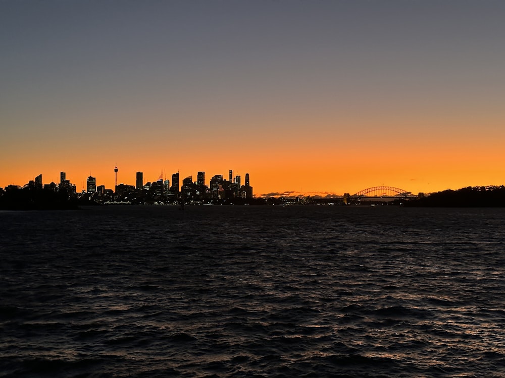 a view of a city from the water at sunset