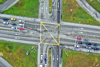 an aerial view of an intersection with a yellow triangle