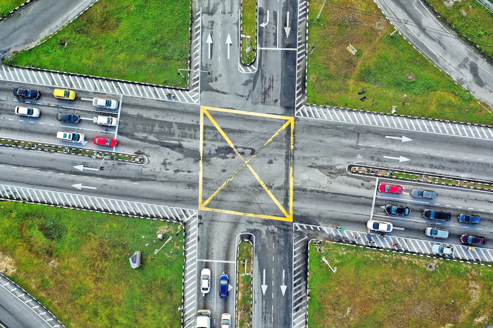 an aerial view of an intersection with a yellow triangle