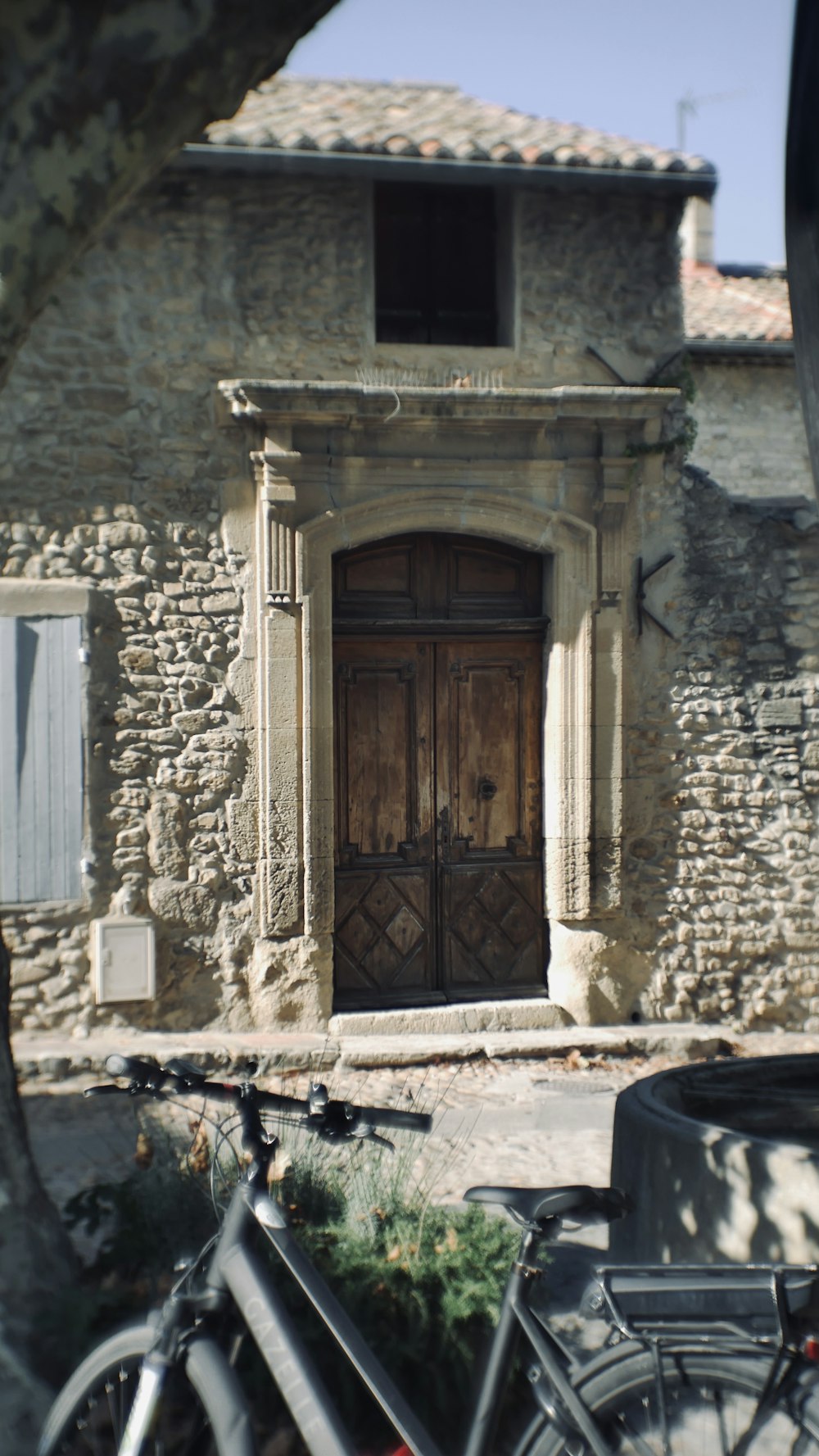 a bicycle parked in front of a stone building