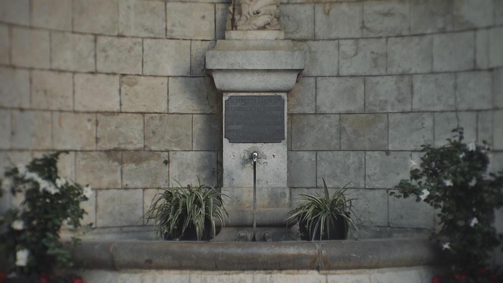 a fountain with a sign on the side of it