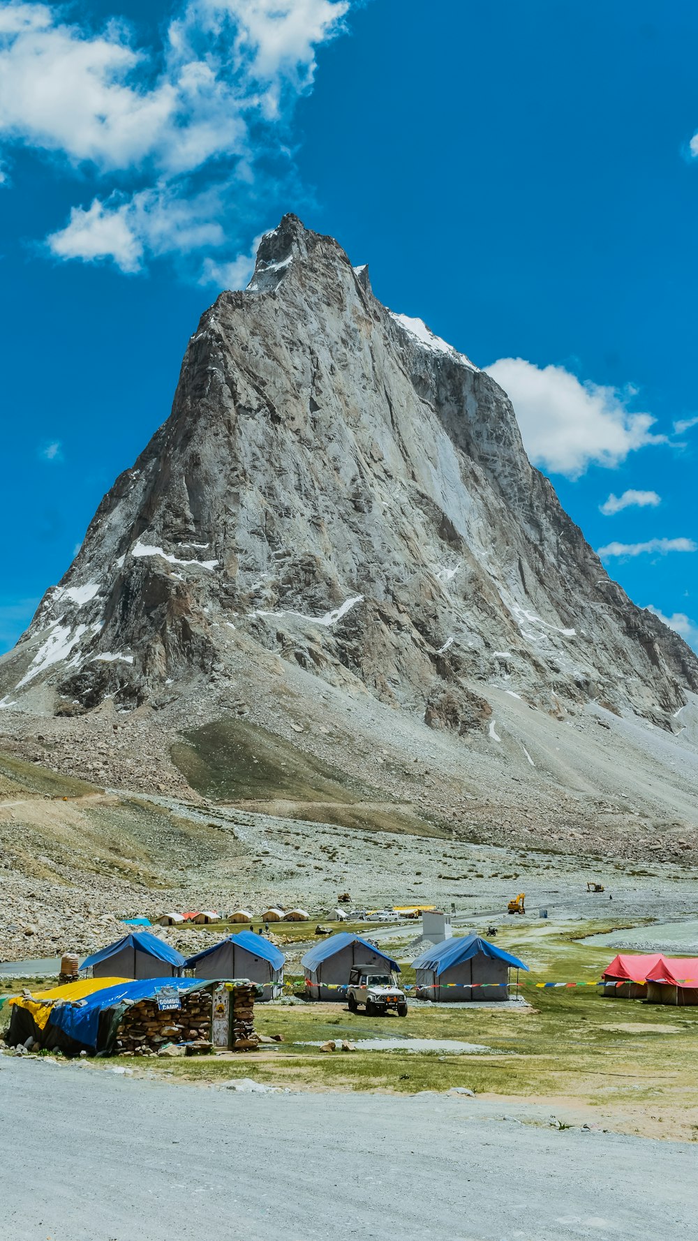 a group of tents set up in front of a mountain