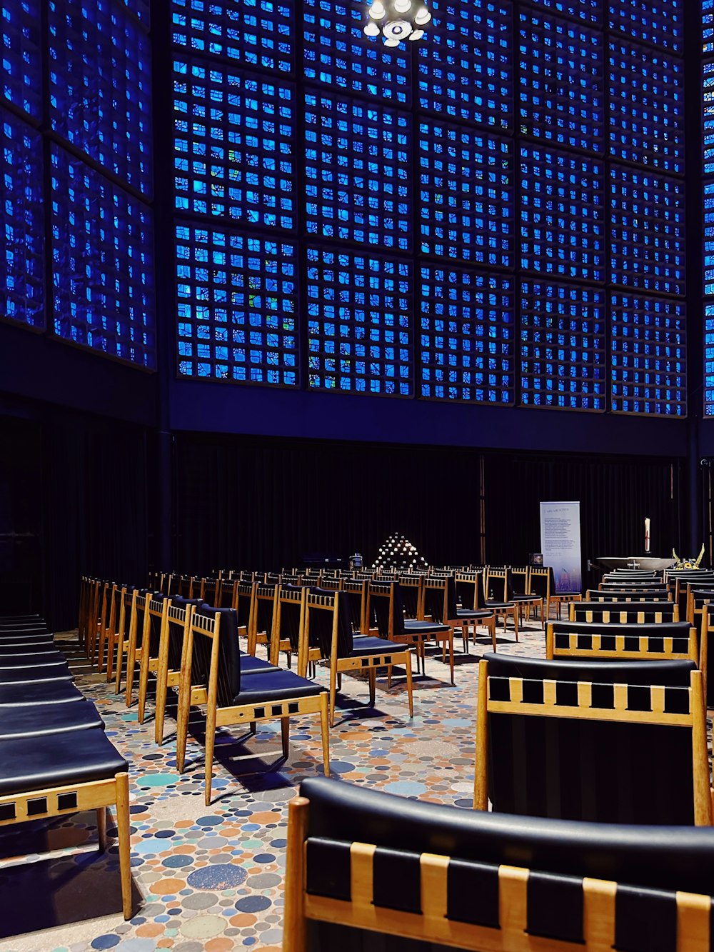 a large room with rows of chairs and a projector screen