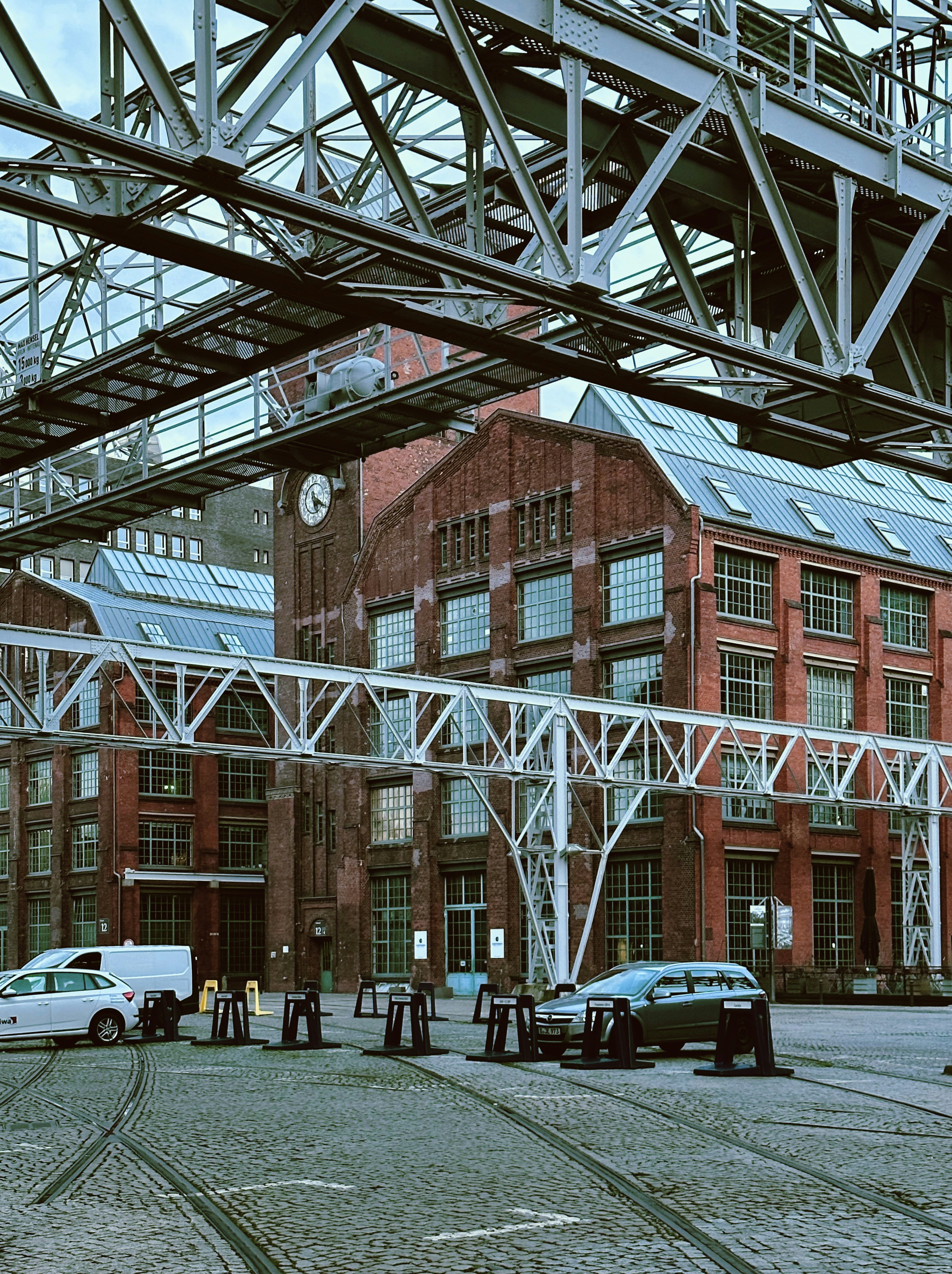 a group of cars parked in front of a red brick building