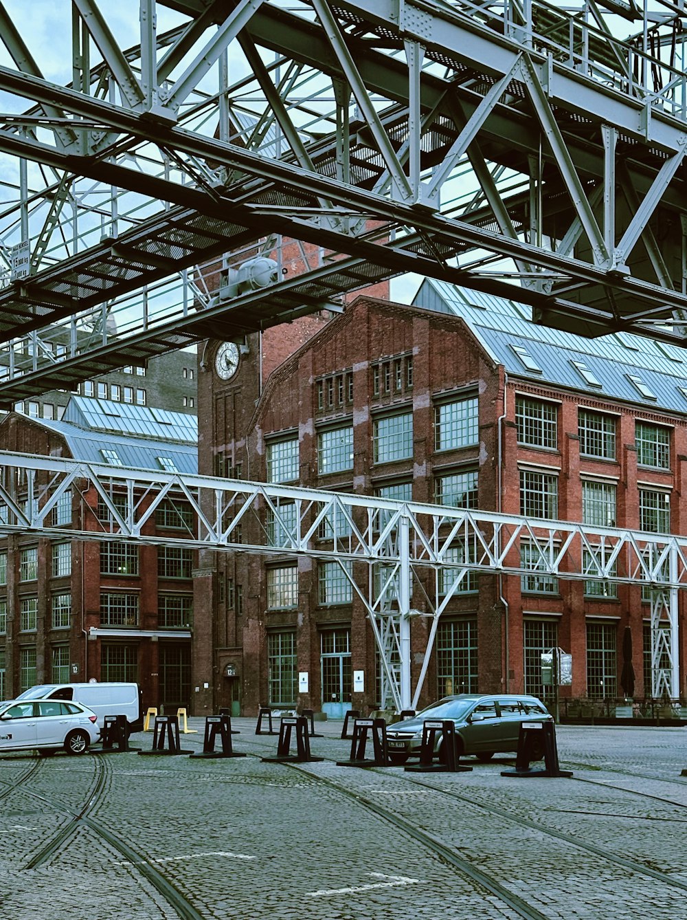 a group of cars parked in front of a red brick building