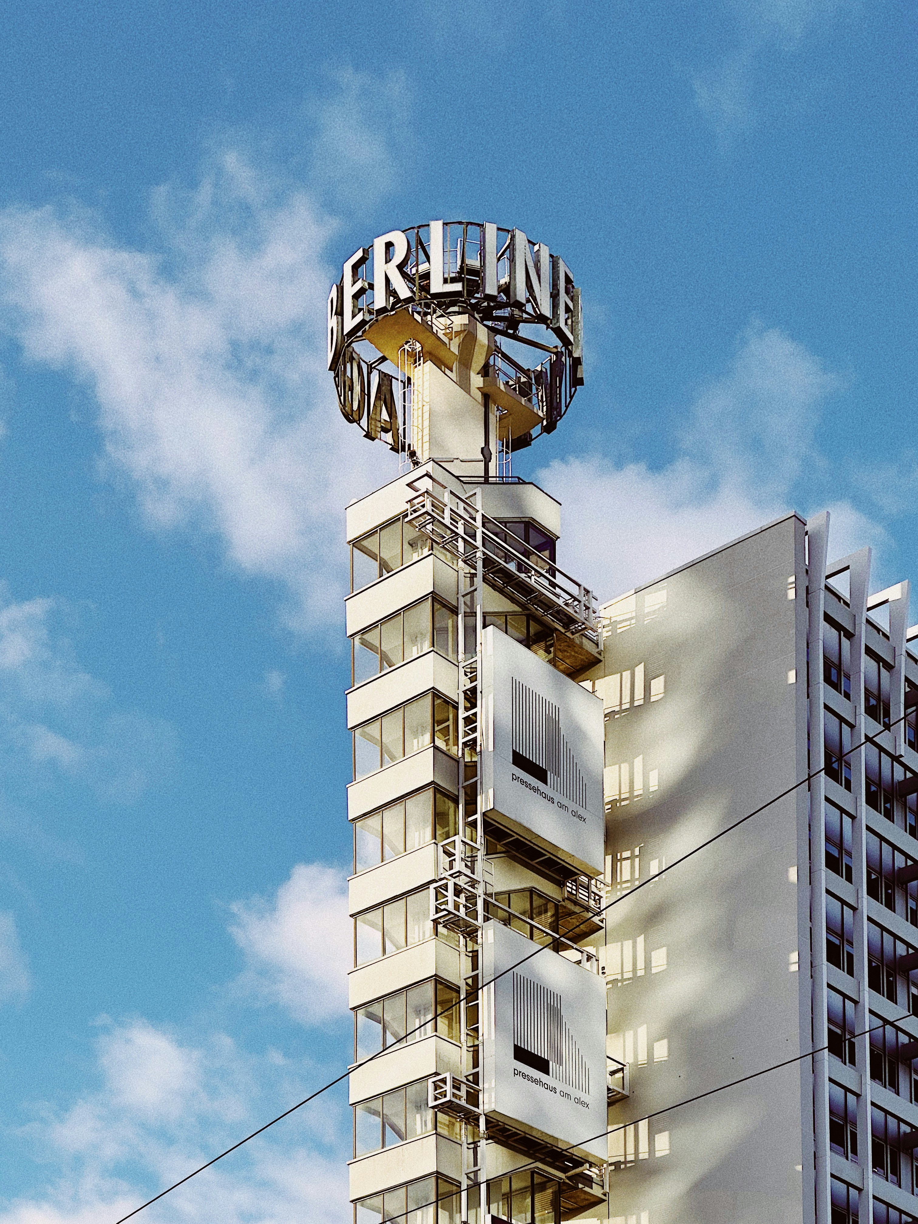 a tall building with a sign on top of it