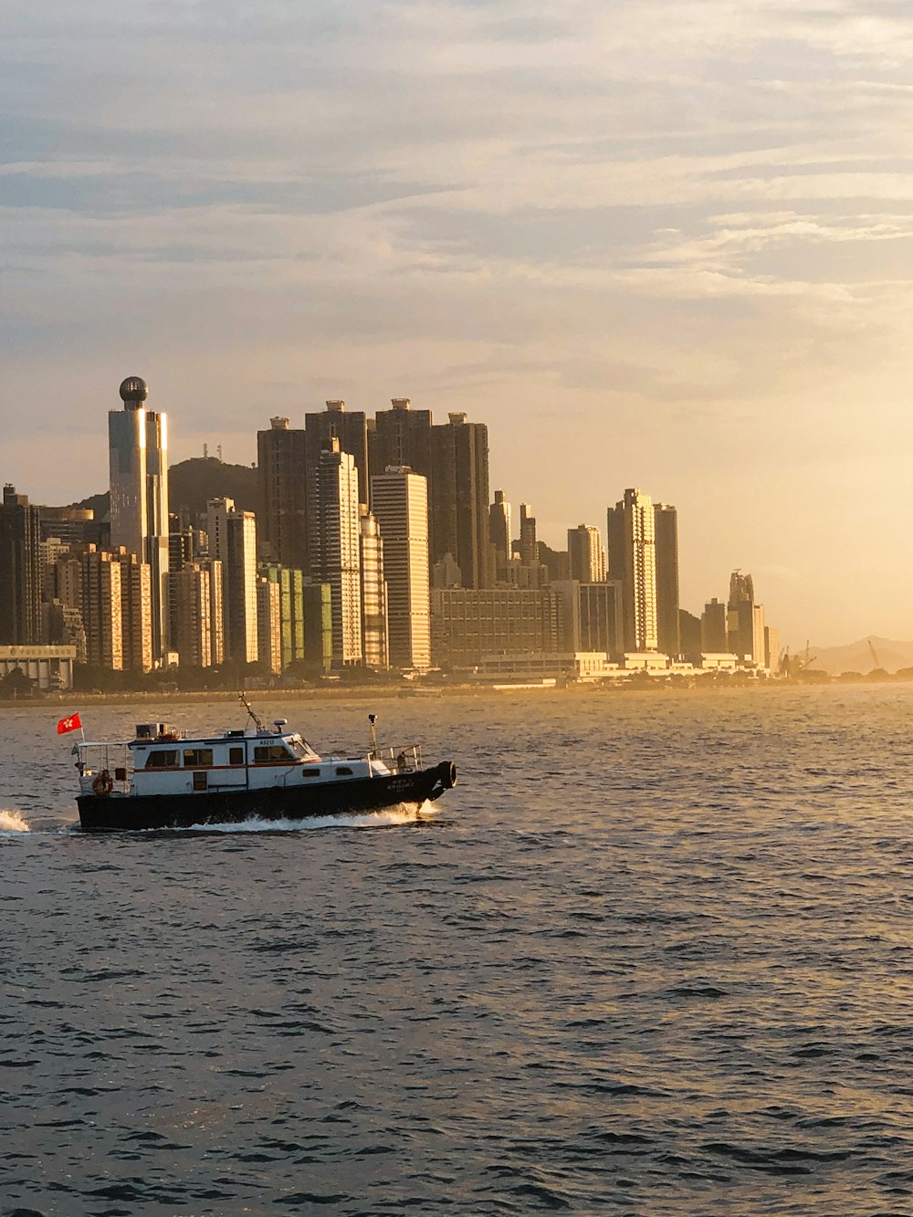 a boat is in the water with a city in the background