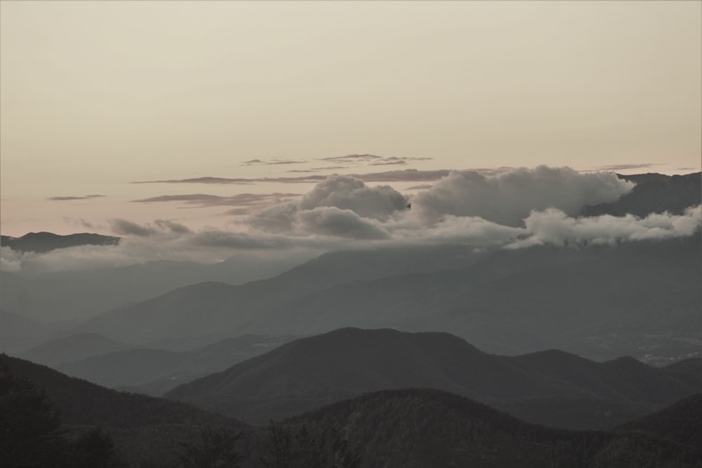 a view of a mountain range with clouds in the sky