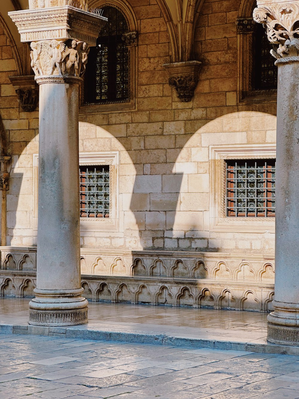 a couple of stone pillars sitting in front of a building