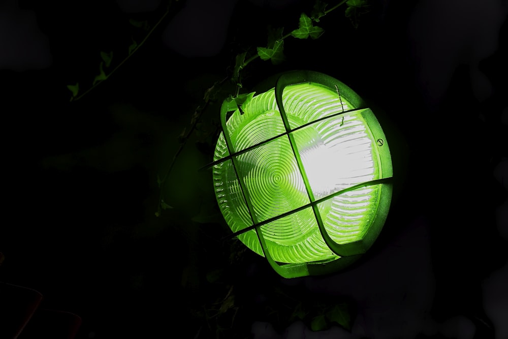 a close up of a green light in the dark