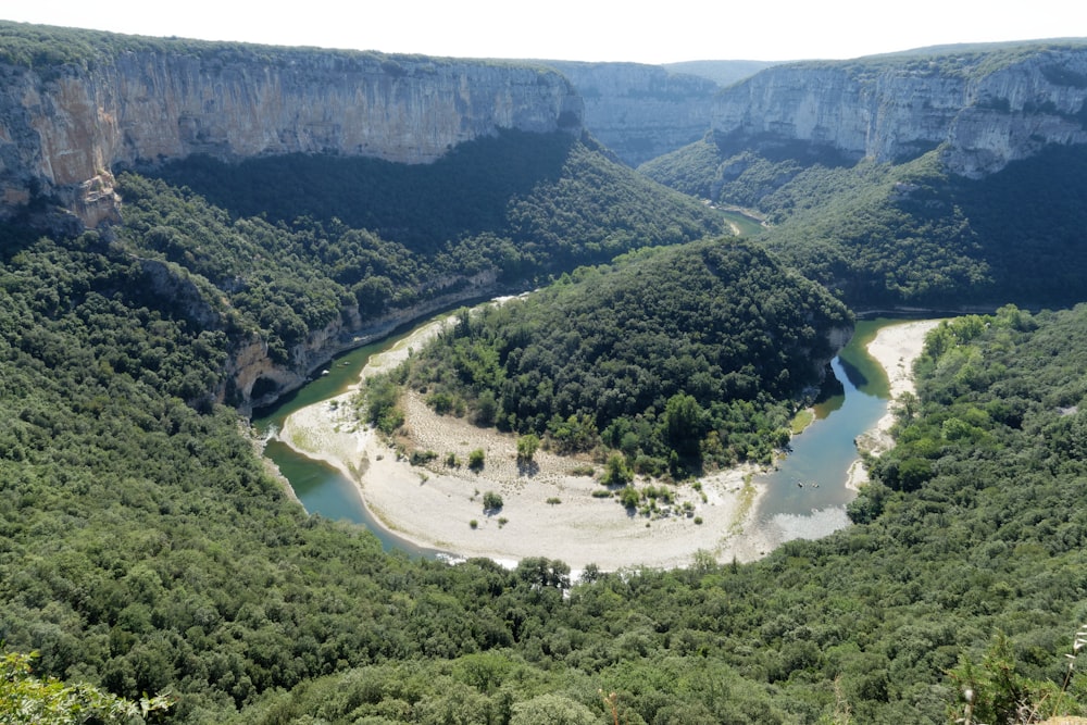 a river flowing through a lush green valley