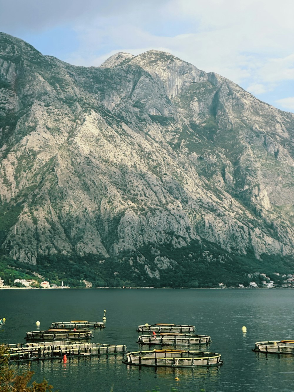 a group of boats floating on top of a lake