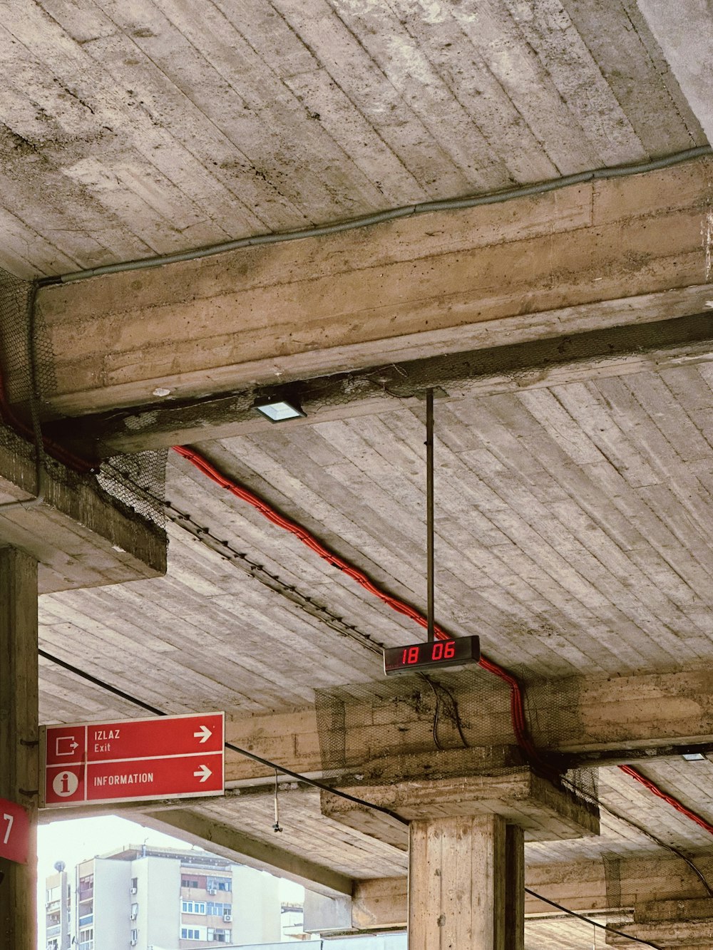 a red street sign hanging from the side of a building