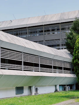 A modern industrial facility with green and gold accents reflecting natural tones.