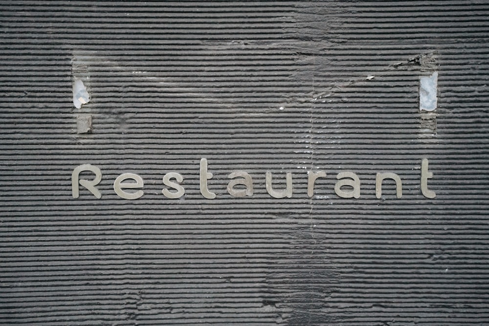 the word restaurant written on the side of a building
