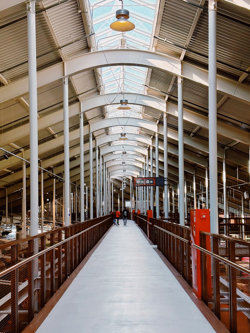 a walkway in a building with a skylight above it