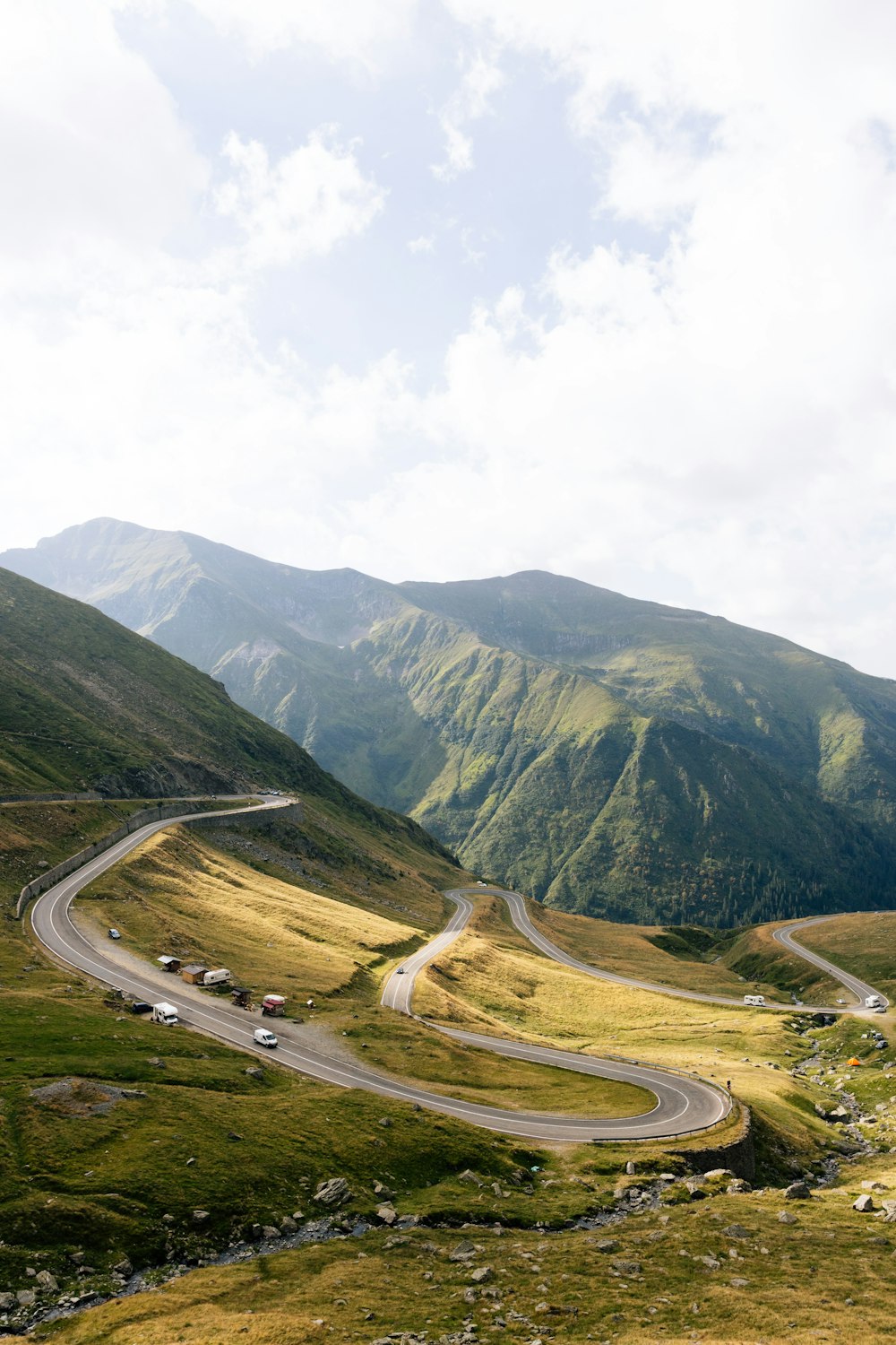 a winding road in the middle of a mountain range