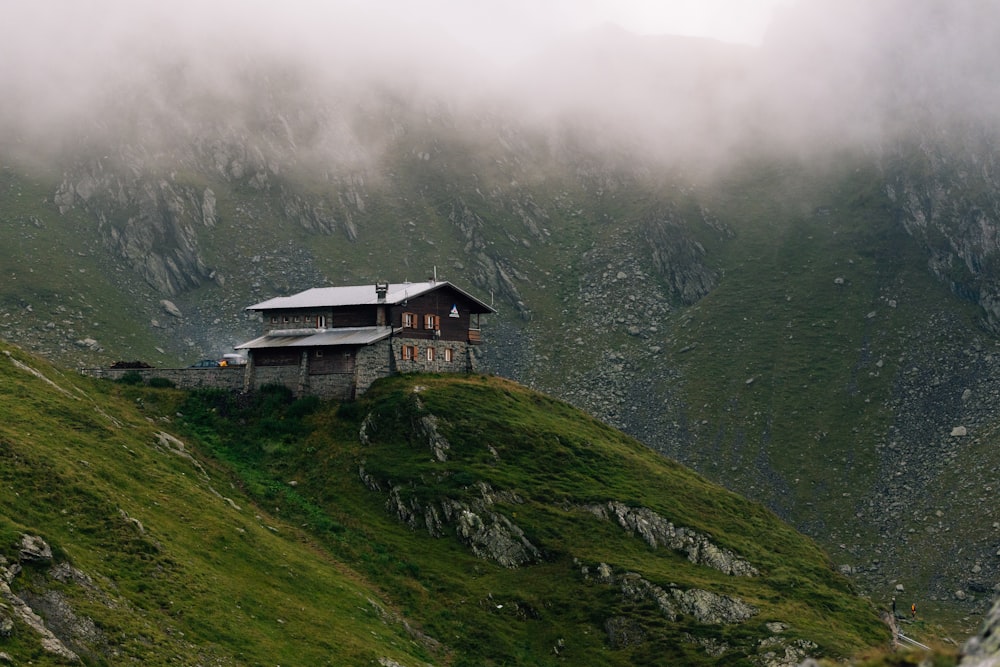 a house sitting on top of a lush green hillside